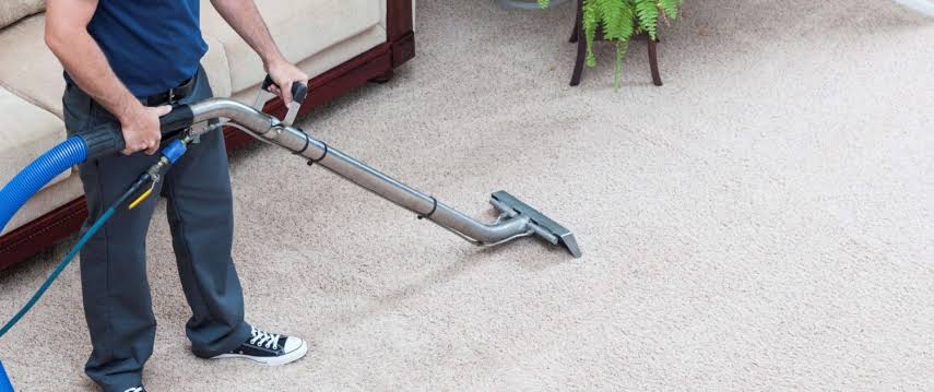 man cleaning carpet